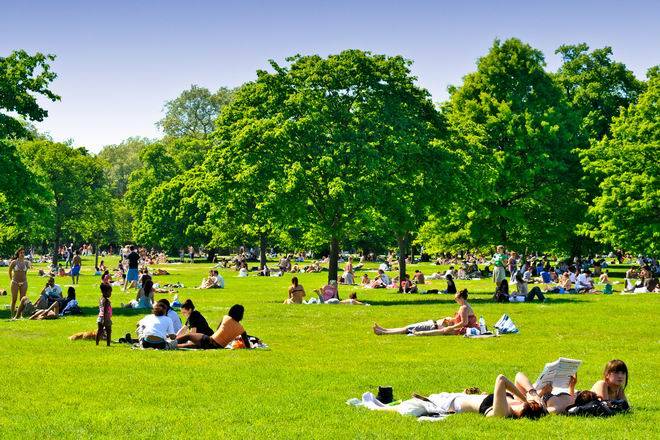 Crowds of people enjoying London's Hyde Park on a sunny summers day, UK
